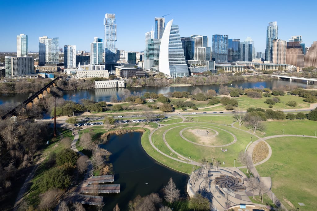 Austin rooftops and tree canopy stretching toward the downtown skyline.