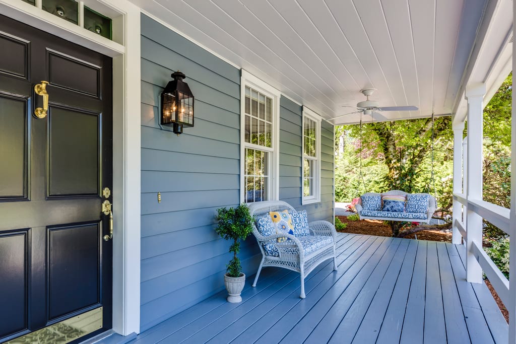 The exterior of a Central Texas home with mature oaks close to the house.