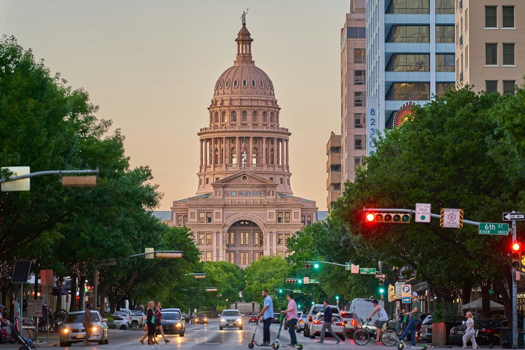 The downtown Austin skyline at dusk, seen across Lady Bird Lake.