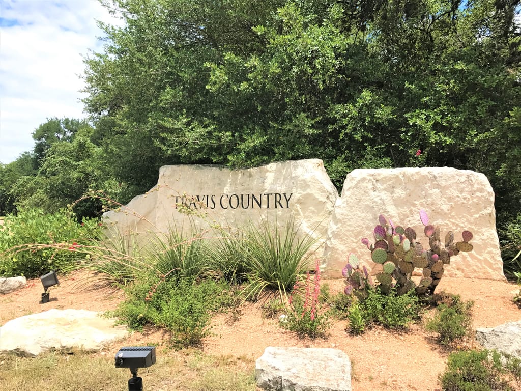 A established home behind mature trees in a south Austin neighborhood.
