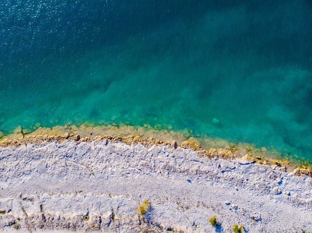 Canyon Lake seen from a limestone bluff, with cedar and live oak along the shoreline