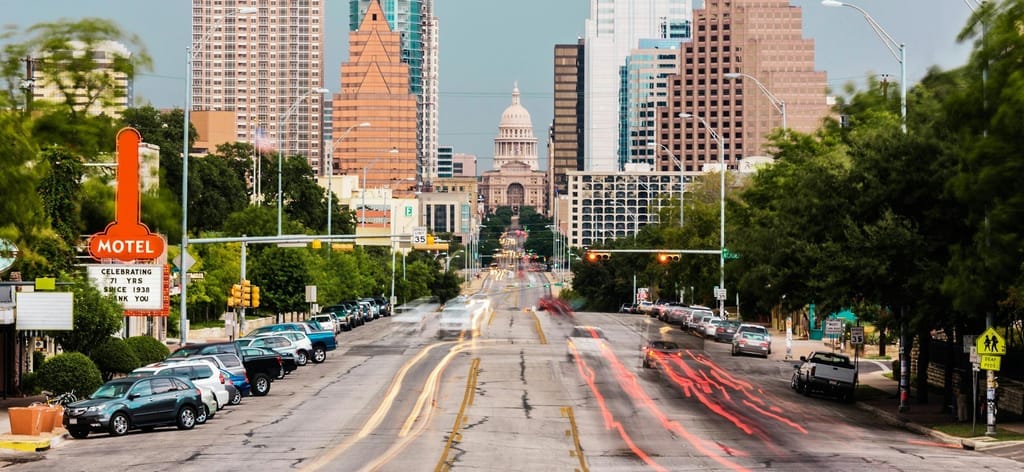 South Congress Avenue in 78704, low storefronts with the downtown skyline behind
