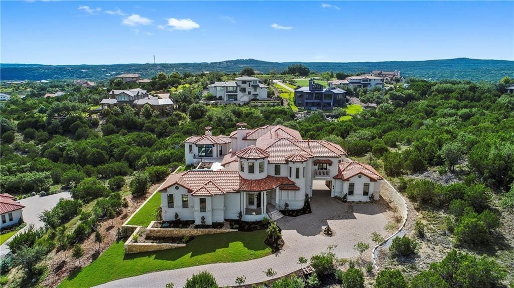 The Spanish Oaks entrance in Bee Cave, stone walls and Hill Country oaks