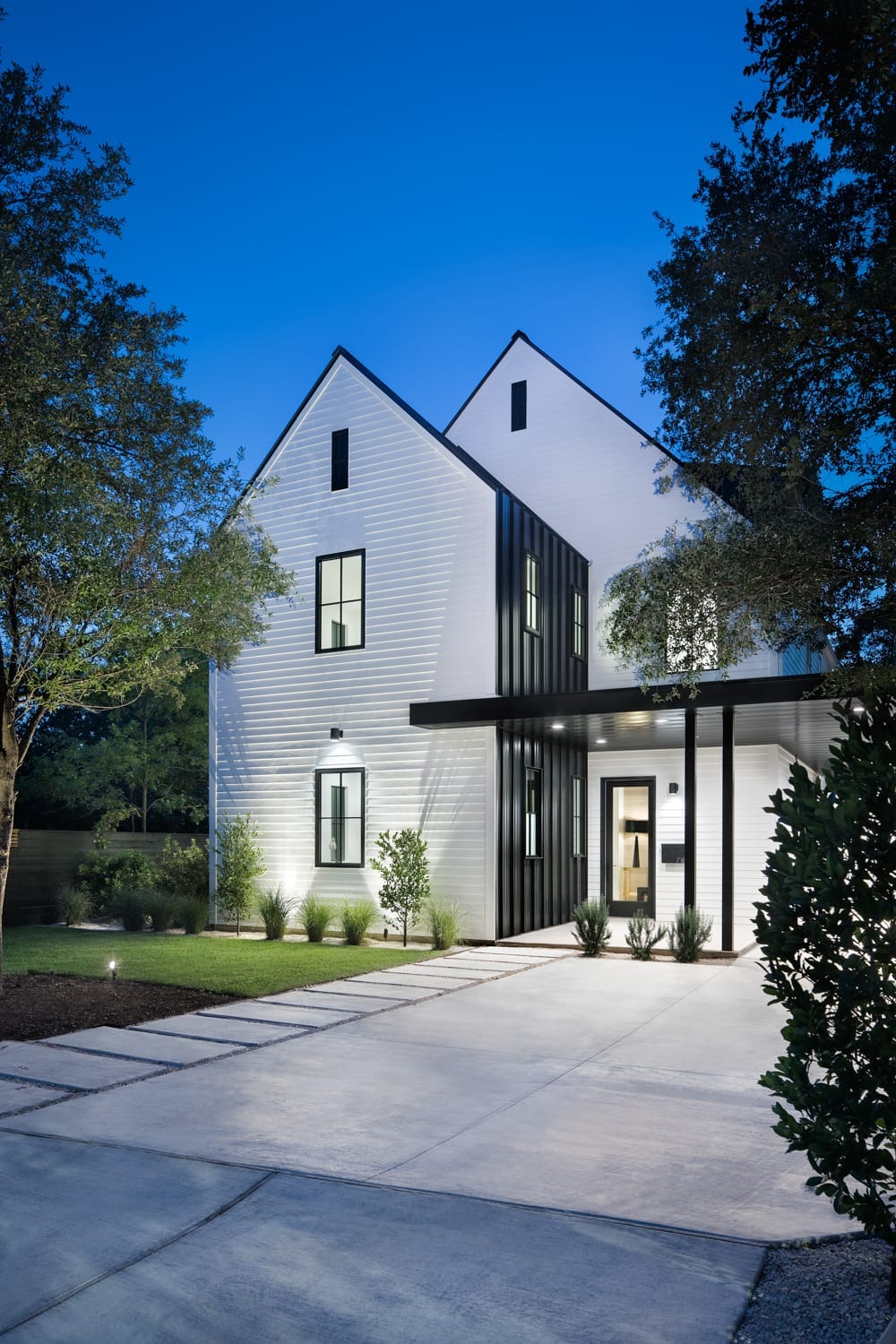 A Tarrytown street of established homes under a canopy of old live oaks