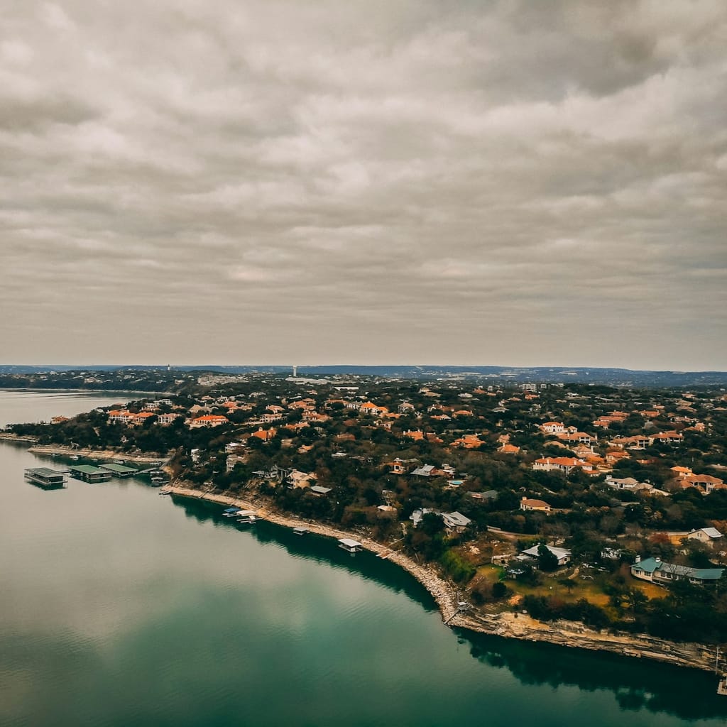 Lake Austin from the air, a wooded peninsula of houses reaching into the water on the south shore