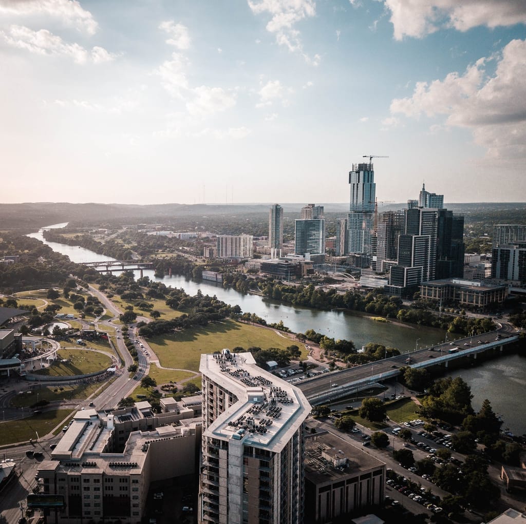 Downtown Austin from the air, the towers of the central business district above the curve of Lady Bird Lake